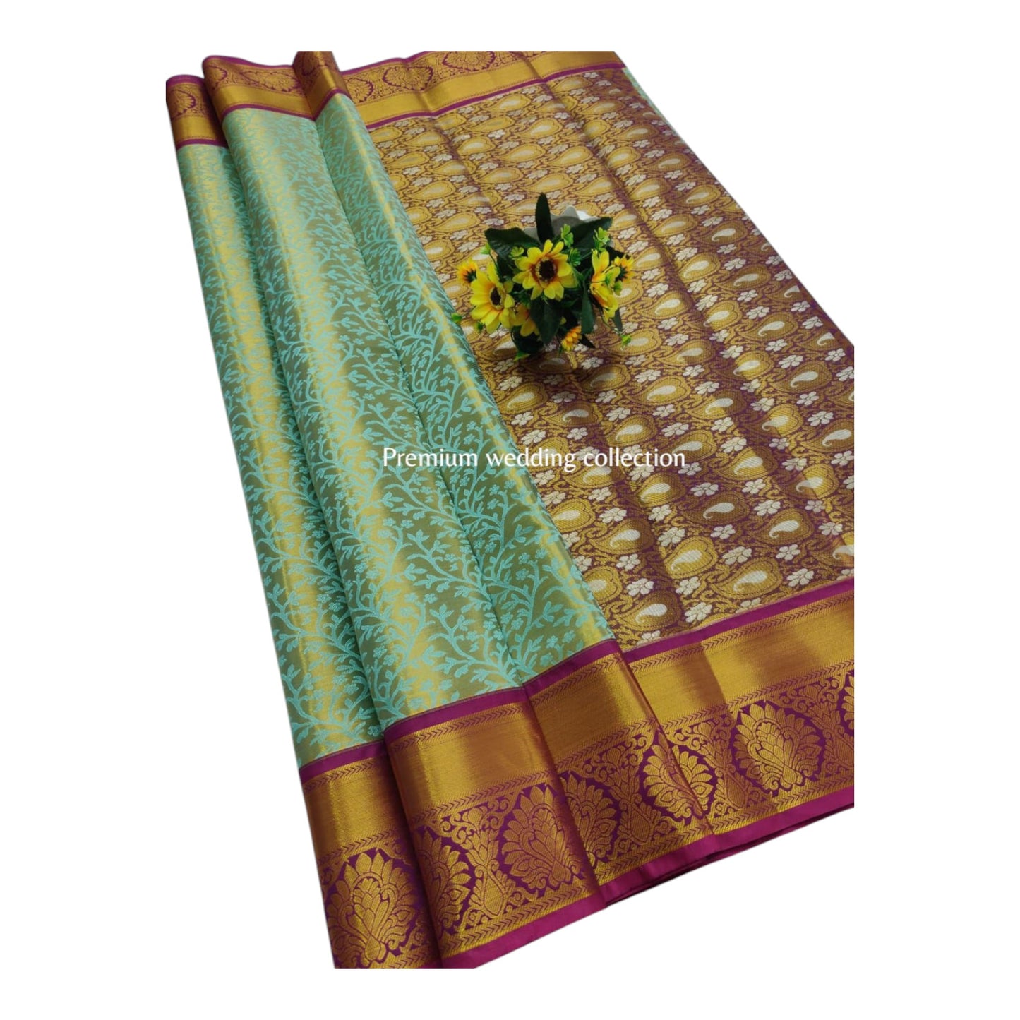 Traditional saree with green and gold patterns on a white background