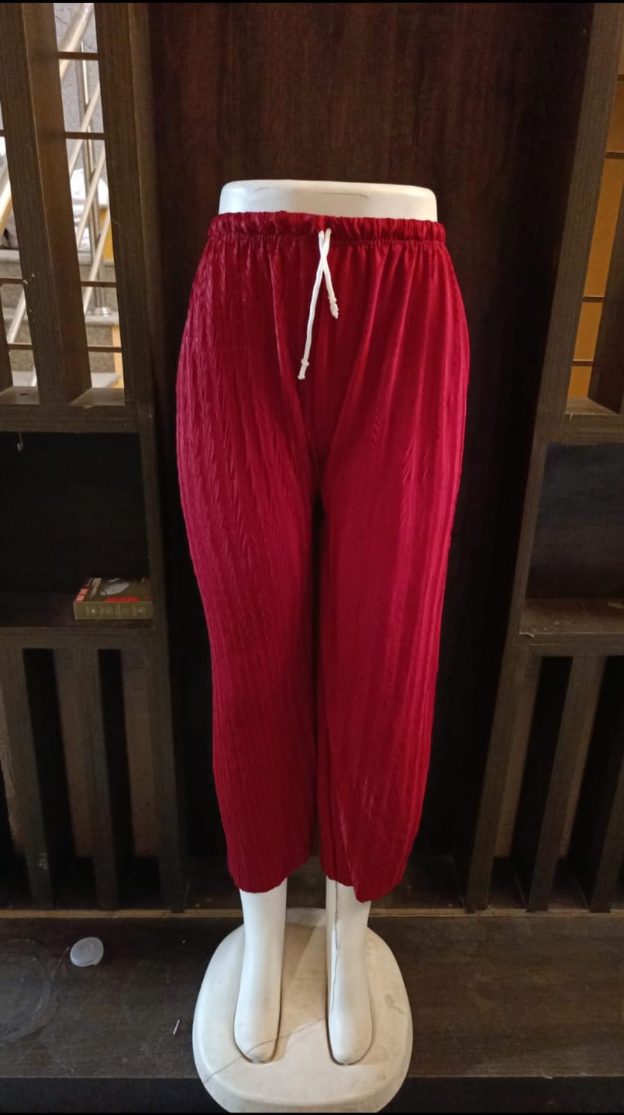 Red pants on a mannequin against a dark background