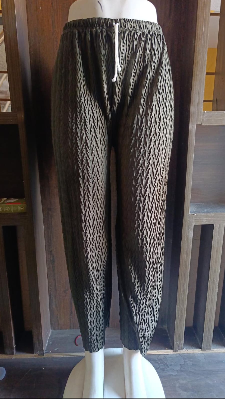 Patterned pants on a mannequin against a white background