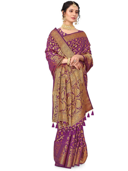 Woman wearing a purple and gold saree with a white background