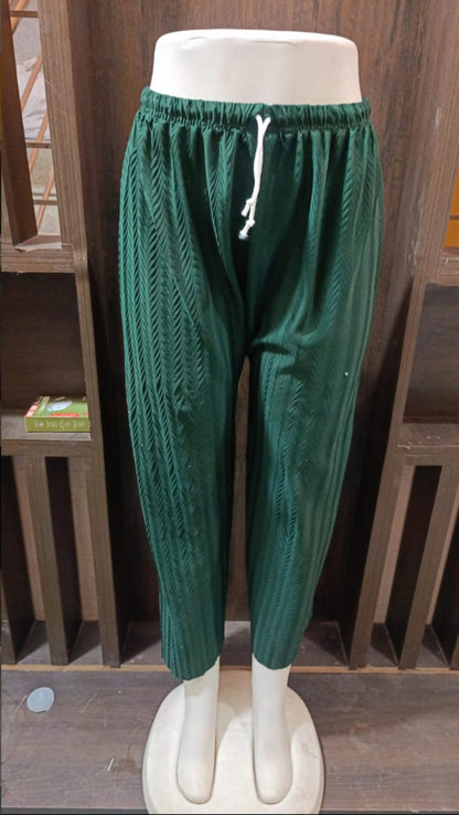 Green pants on a mannequin against a white background