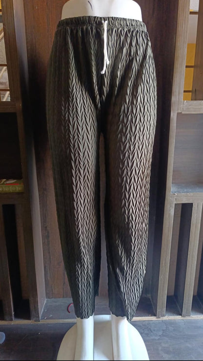 Patterned pants on a mannequin against a white background