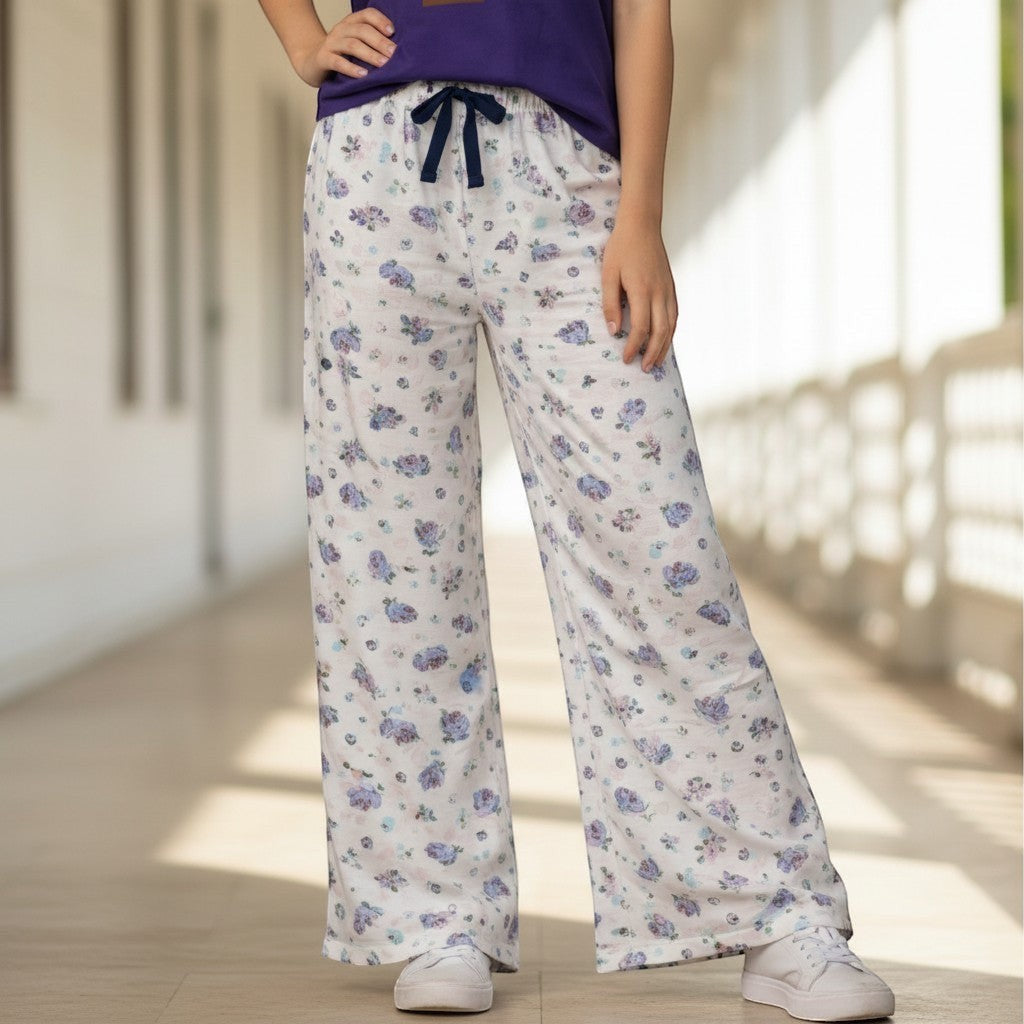 For She - Avalukaaga white wide leg pajama pants with a blue floral print and navy drawstring.