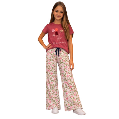 For She - Avalukaaga girl wearing pink floral wide leg pajama pants and a matching t-shirt with floral graphic.