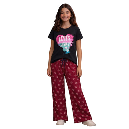 For She - Avalukaaga girl in red pajama pants with white heart print and black t-shirt with Levi's heart graphic.